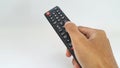 Hand holding television remote control on white background Royalty Free Stock Photo