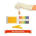 Hand holding test tube with pH indicator