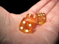 Hand holding three dice on a black background Royalty Free Stock Photo