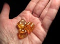 Hand holding three dice on a black background Royalty Free Stock Photo