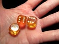 Hand holding three dice on a black background Royalty Free Stock Photo