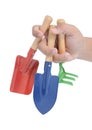 Hand holding three garden tools