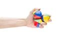 Hand holding three juggling balls