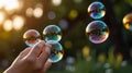 Hand holding three soap bubbles with nature reflecting on them at sunset Royalty Free Stock Photo
