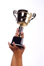 A hand holding a throphy Royalty Free Stock Photo