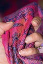 Hand holding tight a pink and purple original cashmere scarf Royalty Free Stock Photo