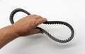 Hand holding the timing belt for motorcycle engine white background