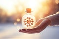 Hand holding Tiny cute christmas contained within a sphere glass bottle on snow background, AI Royalty Free Stock Photo