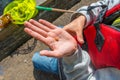 Hand holding a tiny orange fish