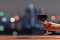 Hand holding and toasting a glass of red wine. Royalty Free Stock Photo