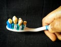 Hand holding toothbrush with teeth conceptual image