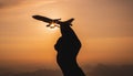 A hand holding a toy plane Go to the sky with sunset light Royalty Free Stock Photo