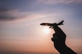 A hand holding a toy plane Go to the sky with sunset light Royalty Free Stock Photo