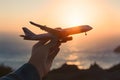 Hand holding toy plane, representing dreams of travel adventures Royalty Free Stock Photo