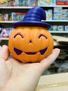 Hand holding toy pumpkin Concept for Halloween holiday