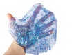 Hand holding a transparent blue glitter slime isolated on white