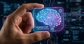 Hand holding holographic digital brain icon representing artificial intelligence and machine learning technology concept image Royalty Free Stock Photo