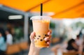 Refreshing peach bubble tea in hand Royalty Free Stock Photo