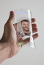 Hand holding transparent future mobile phone made of graphene. Concept.