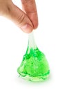 A hand holding a transparent green slime isolated on white with clipping path.