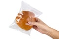 Hand holding transparent plastic bag with bread isolated on white with clipping path