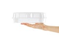 Hand holding transparent plastic container. Close up. Isolated o Royalty Free Stock Photo