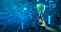 Hand holding Tree growing in light bulb. Ecology, Technology Convergence, Green Computing, and IT Ethics Royalty Free Stock Photo