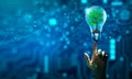 Hand holding Tree growing in light bulb. Ecology, Technology Convergence, Green Computing, and IT Ethics Royalty Free Stock Photo