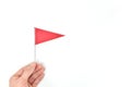 Hand holding triangle red flag. Danger warning and reaching goal concept Royalty Free Stock Photo