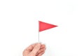 Hand holding triangle red flag. Danger warning and reaching goal concept Royalty Free Stock Photo