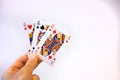 Hand holding a trio of queen cards of poker over a white background Royalty Free Stock Photo