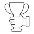 Hand holding trophy cup thin line icon, sports concept, golden goblet sign on white background, cup icon in outline Royalty Free Stock Photo