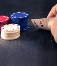 Hand holding two aces, poker chips, retro color look Royalty Free Stock Photo