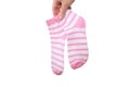 A hand holding two, pair pink and white striped cotton organic socks isolated on white Royalty Free Stock Photo