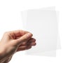 A hand holding two transparent sheets of paper against a plain background isolated on white background Royalty Free Stock Photo
