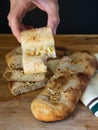 Hand holding typical Catalan sweet with bread dough, sugar and almonds or pine nuts