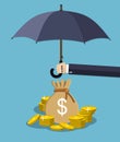 Hand holding umbrella under rain to protect money. Royalty Free Stock Photo