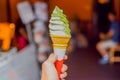 A hand holding up a matcha ice-cream cone Royalty Free Stock Photo