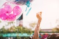 Hand holding up rope of greeting balloon for special event or bi Royalty Free Stock Photo