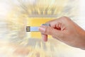 Hand holding USB data storage against light and circuit Royalty Free Stock Photo