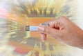 Hand holding USB data storage against light and circuit Royalty Free Stock Photo
