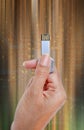 Hand holding USB data storage against light and circuit Royalty Free Stock Photo