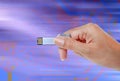 Hand holding USB data storage against light and circuit Royalty Free Stock Photo