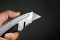 Hand holding Utility knife Royalty Free Stock Photo