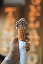 A hand holding vanilla and chocolate ice cream or gellato on a cone Royalty Free Stock Photo