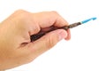 Hand holding very old crochet hook isolated on a