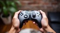 hand holding video controller, close-up of hand holding gamepad, gamer playing game with gamepad