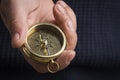 Hand holding a vintage compass with copy space, close up, selective focus Royalty Free Stock Photo