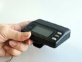 A hand holding Vintage model of Wireless telecommunication, pager, paging, message device, early stage of communication equipment Royalty Free Stock Photo