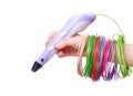 Hand holding violet 3D drawing pen printer on white background. Plastic PLA and ABS filament material for printing.Copy space for Royalty Free Stock Photo